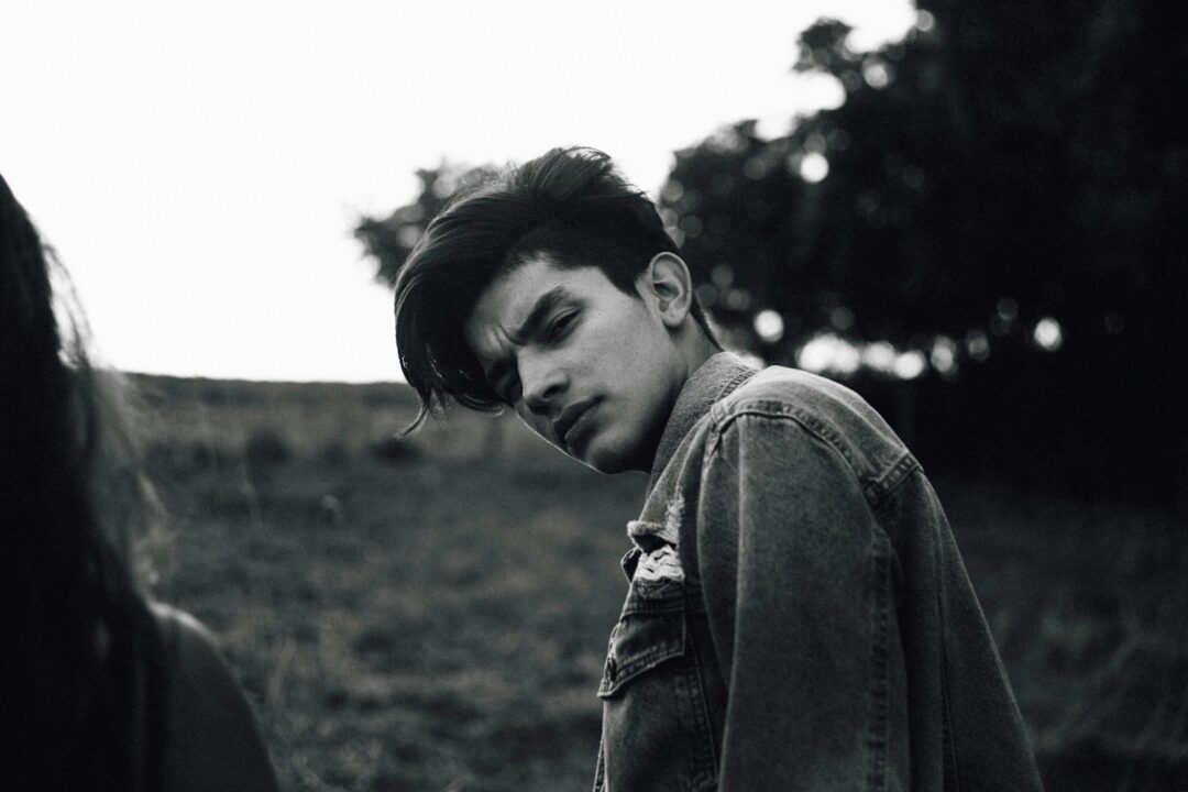 grayscale photo of man wearing jacket